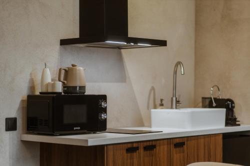 a microwave sitting on a counter in a kitchen at Buntes nams l Self check-in l Private entrance in Limbaži
