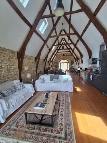a large room with two beds and a table at La Source de Diège in Loupiac