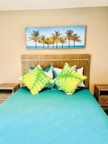 a bedroom with a blue bed with palm trees at Wake up 2 Quiet Ocean Views, centrally located A1A in Ormond Beach