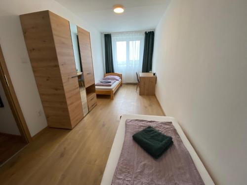 a room with a bed and a room with a cabinet at Nagyerdő Naplemente Apartman Debrecen in Debrecen