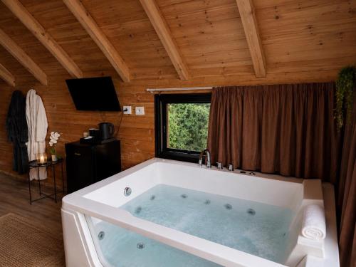 a large bath tub in a room with a window at Thethi Villas in Theth