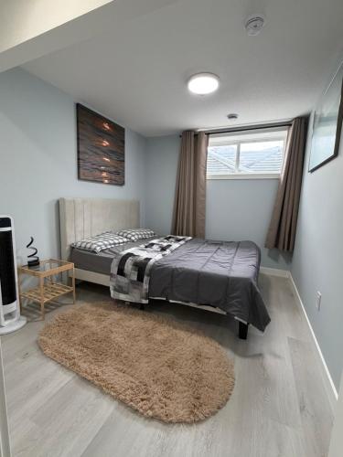 a bedroom with a bed and a rug at Entire 2BR Suite 12 min to Airport in Calgary