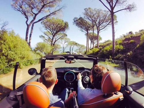 a group of people in a car driving down a road at The Glen Boutique Hotel & Spa in Cape Town