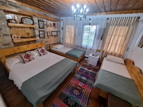 a bedroom with two beds in a log cabin at "Villa 70" Guesthouse in Gjirokastër