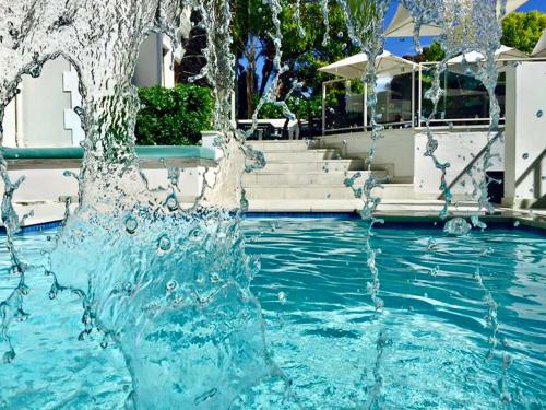 a water fountain in the middle of a swimming pool at The Glen Boutique Hotel & Spa in Cape Town
