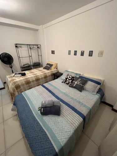 two beds sitting in a room with at Hospedagem Dorna Itaguaí Casa 6B in Itaguaí