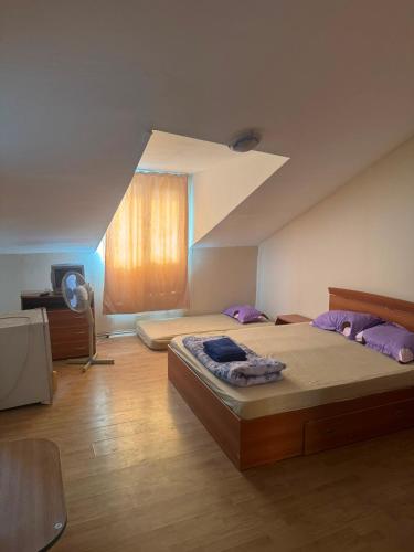 a large bedroom with two beds and a window at Vila George in Eforie Sud