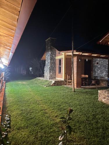 a house with a yard at night at Zidada Mundo Magico in Huasca de Ocampo