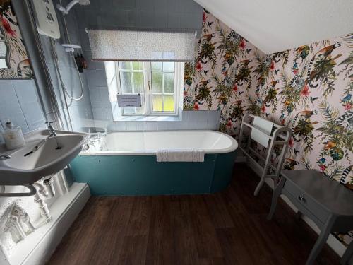 a bathroom with a bath tub and a sink at Bolton arms downholme in Richmond