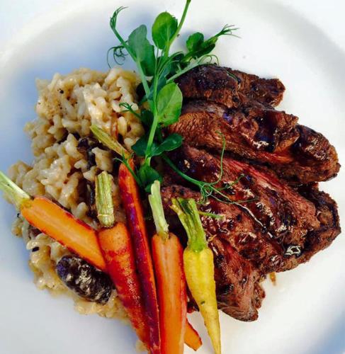 a plate of food with meat and carrots and rice at The Glen Boutique Hotel & Spa in Cape Town