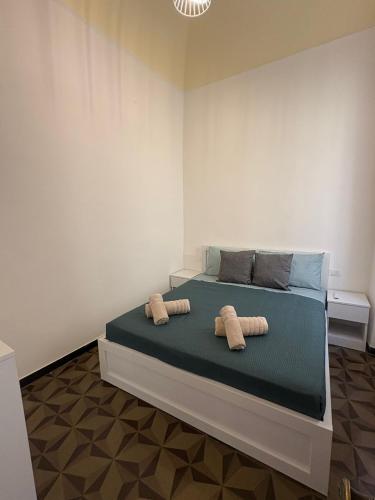 a bedroom with a bed with two towels on it at Riviera Blu Rooms in Laigueglia
