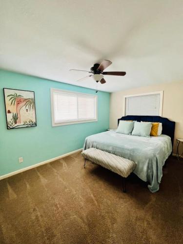 a bedroom with a bed and a ceiling fan at Steps to Private Beach Access King Beds in Ormond Beach