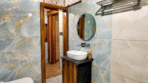 a bathroom with a sink and a mirror at Kaya Nature Resort in Ajabgarh