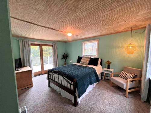 a bedroom with a bed and a chair in it at Ahmeek-5 in Dover