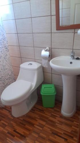 a bathroom with a toilet and a sink at Camping Las Torcacitas in Yerbas Buenas