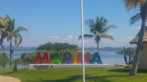 a sign with the word miami in front of the water at Alexia Marina Diamante in Acapulco