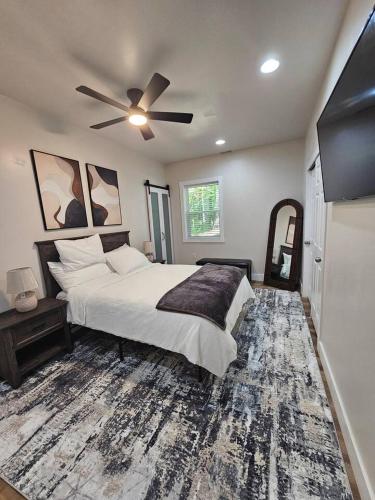 a bedroom with a bed and a ceiling fan at Nest in the City in Fort Mill