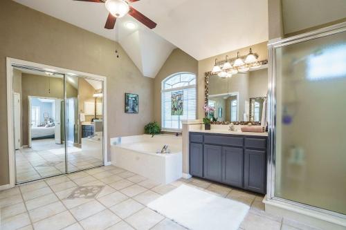 a large bathroom with a tub and a shower and a sink at 3BR home with private pool 3 mins 2 Riverplace in Austin