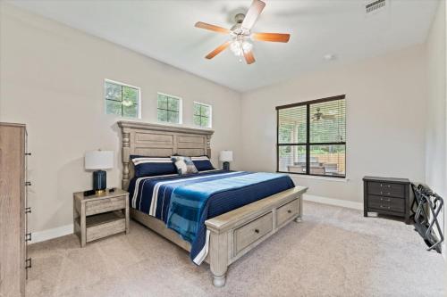 a bedroom with a bed and a ceiling fan at Pines and Patio Hideaway in Conroe