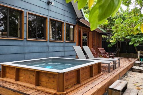 a hot tub on the deck of a house at Fare Vainina Private beach - Golf in Moorea