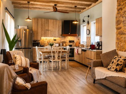 a kitchen and living room with a table and chairs at Villa Katrinia in Sitia