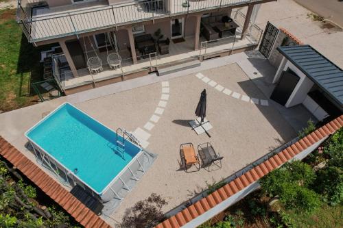 an overhead view of a swimming pool and an umbrella at Zen Suite in Umag
