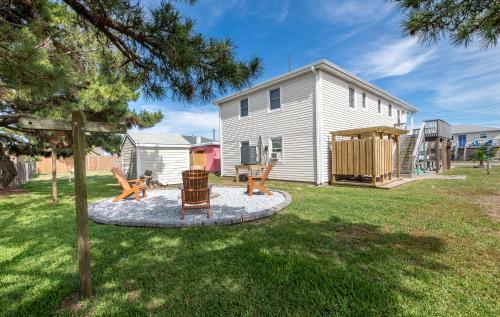 a yard with two chairs and a playground at Turtle-ly Beachin' - KDH MP 6, Ocean View, Beach 165 Yds, Sound Access, Year Round Flex Stays in Kill Devil Hills