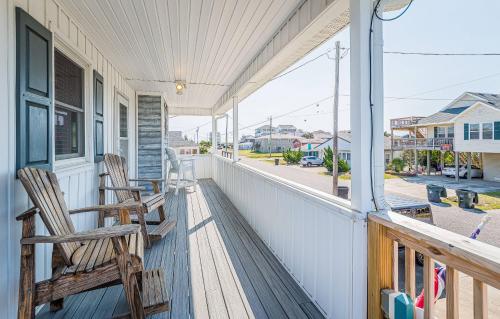 two chairs on a porch with a view of a street at Turtle-ly Beachin' - KDH MP 6, Ocean View, Beach 165 Yds, Sound Access, Year Round Flex Stays in Kill Devil Hills