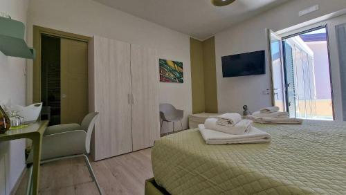 a bedroom with two beds with towels on them at marte rooms in Centola