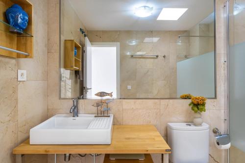 a bathroom with a sink and a toilet at Casa Ocean Love Sea View Duplex Tauro Golf in Mogán