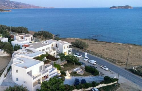 an aerial view of a large white house next to the ocean at Aktio Studios in Gavrio