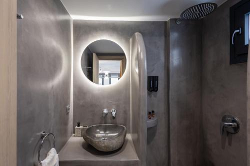a bathroom with a sink and a mirror at Aerial Villas in Imerovigli