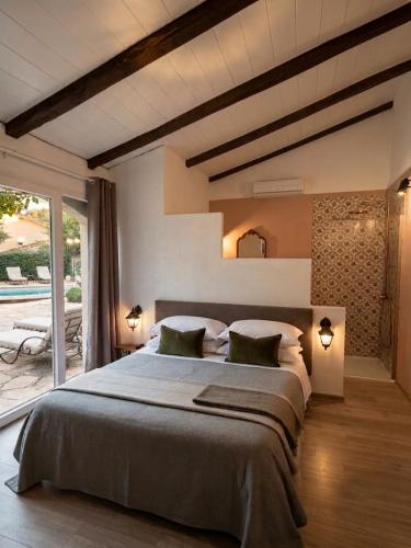 a bedroom with a large bed with two pillows at La Bastide des Mûriers in Deaux