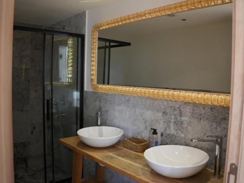 a bathroom with two sinks and a mirror at Ciftlique Otel Cesme in Çeşme