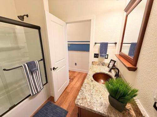 a bathroom with a sink and a shower at Lakefront Villa with Dock Swim Platform in Lake Ozark