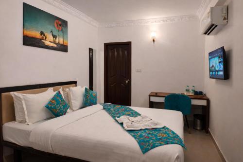 a bedroom with a bed with shoes on it at Guest House Suites in Bangalore