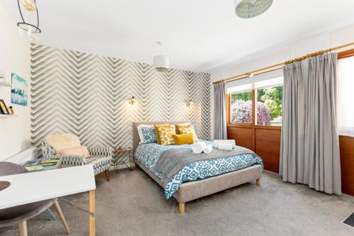 a bedroom with a bed and a desk at Glenarch House in Dalkeith