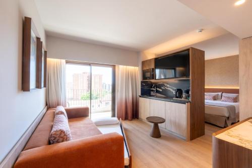 a living room with a couch and a bed at Turia Badajoz in Badajoz