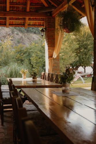 a wooden table and chairs on a patio at Zicka plaza in Kraljevo