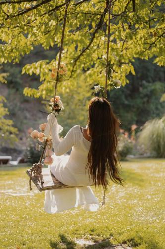 a woman sitting on a swing in a park at Zicka plaza in Kraljevo