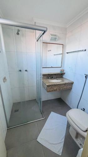 a bathroom with a shower with a toilet and a sink at Prince Hotel in Ribeirão Preto