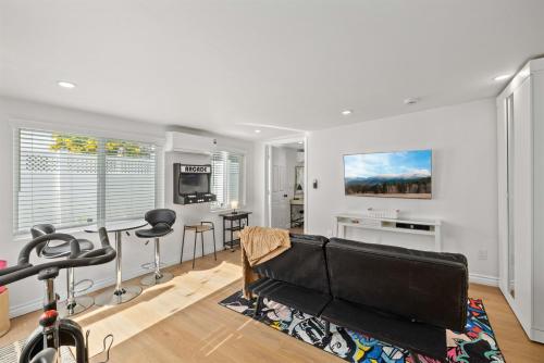 a living room with a couch and a table at Newly Renovated 1BR Suite, Patio BBQ, Fire Pit in Simi Valley