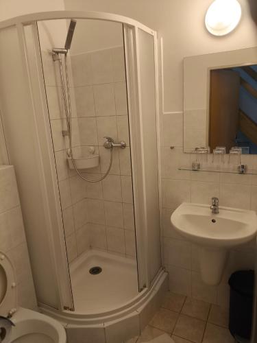 a bathroom with a shower and a sink at Penzion-BelBar Zlín in Zlín