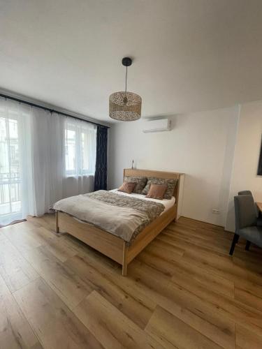 a bedroom with a bed and a chair in it at Central Comfort Studio Walkup in Slezská Ostrava