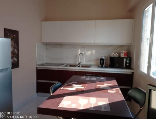 a kitchen with a table with chairs and a sink at Andrea House in Berat