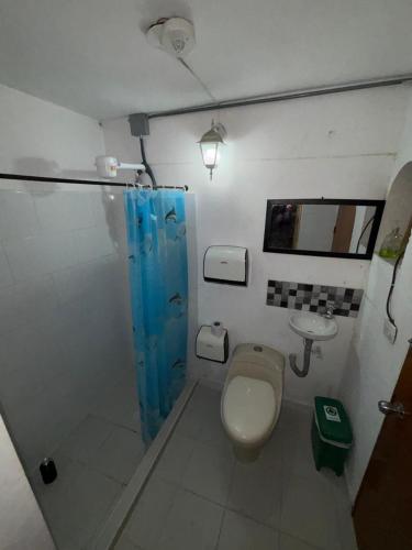 a bathroom with a toilet and a sink at Casa Raizal in Envigado