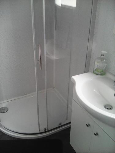 a white shower with a glass door next to a sink at yeolde 2 bedroom Seashak Detached Cottage LOW 2026 PRICES NEWLY REFURBISHED PLUS FREE ALL ELECTRIC ENJOY in Bridlington