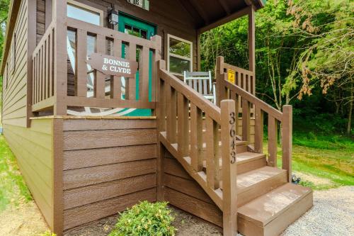 a small house with a wooden staircase leading to a porch at Bonnie & Clyde in Cate crossroad