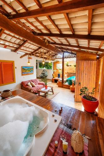 a large room with a bath tub in the middle at Chalés Terraviva in Pirenópolis