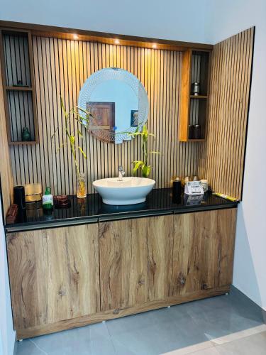 a bathroom with a sink and a mirror on a counter at Villa Lemon in Varkala